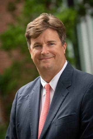 a close up of a person wearing a suit and tie