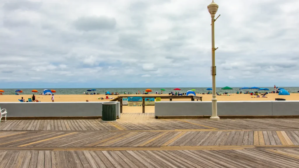 a boardwalk on a beach next to the ocean