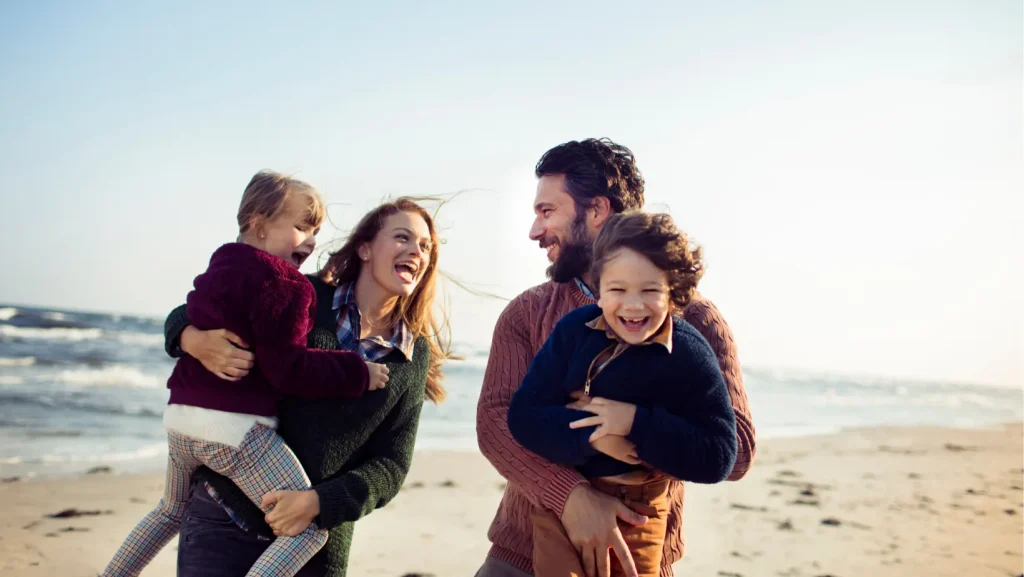 a group of people standing on top of a sandy beach