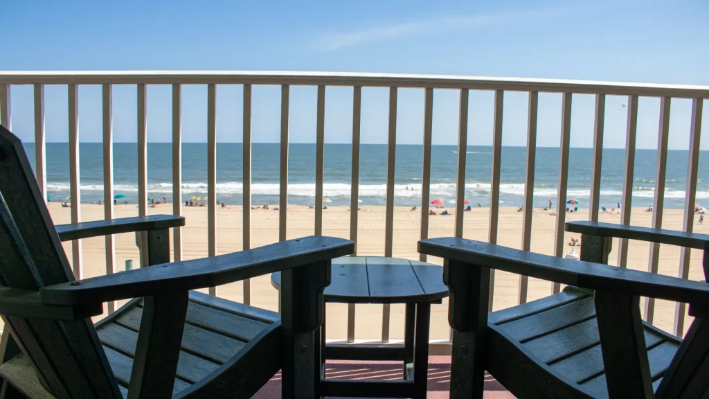 a couple of chairs sitting on top of a balcony