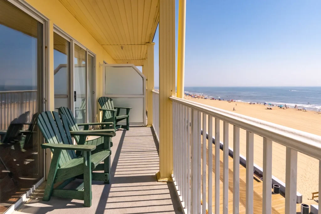 a row of green chairs sitting on top of a balcony