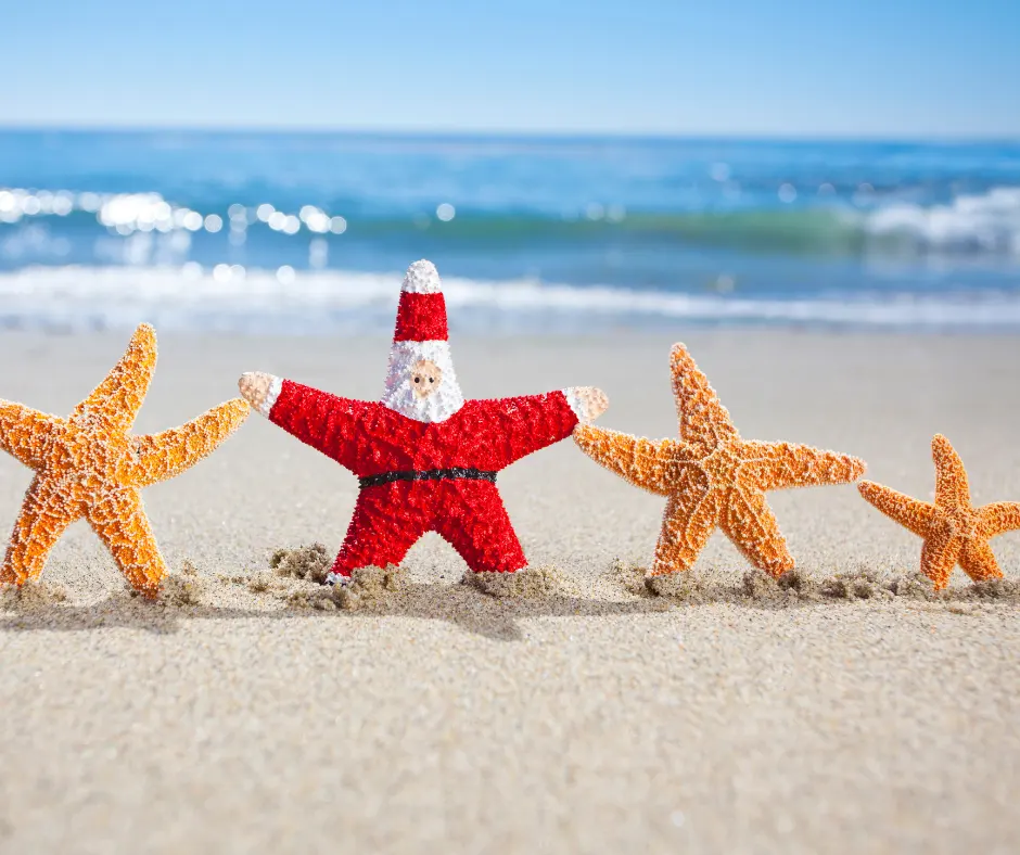 a santa clause figure standing in the sand next to five starfish
