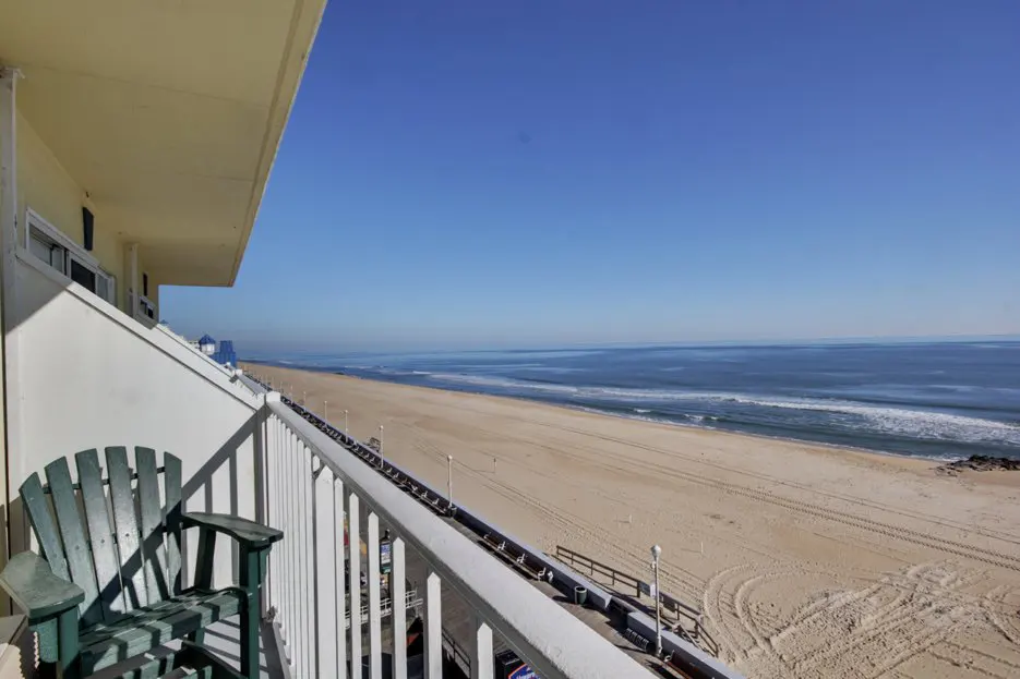 a balcony with a view of the beach and ocean