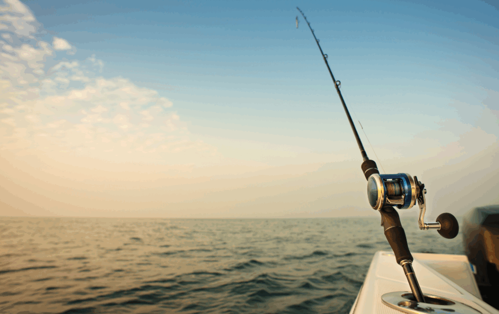 fishing rod on the edge of boat in ocean
