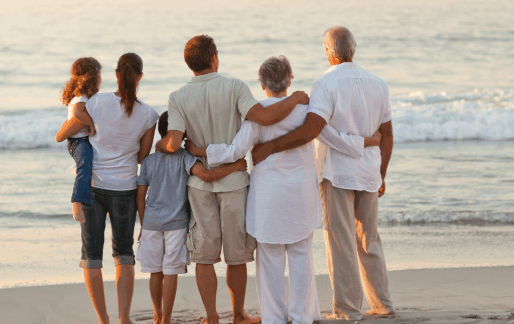 a group of people standing on top of a sandy beach
