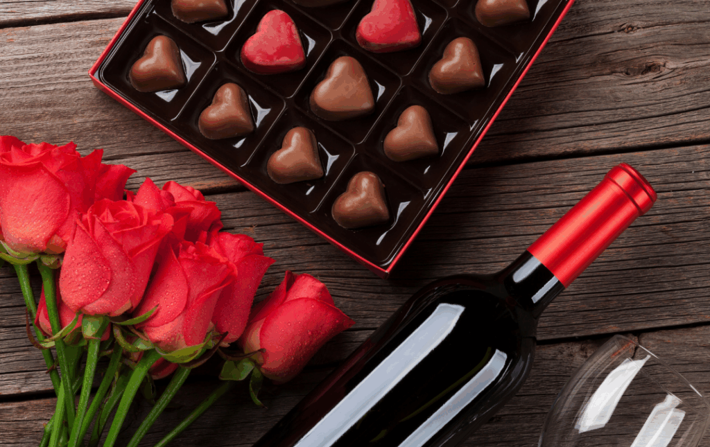 a bottle of wine and some chocolates on a table
