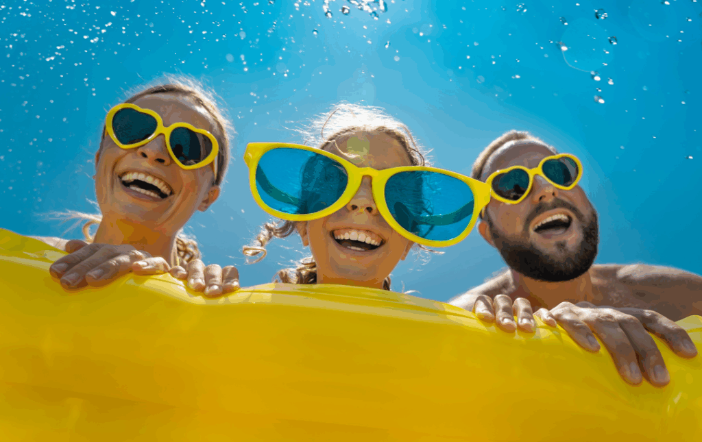 a group of people wearing yellow sunglasses in the water