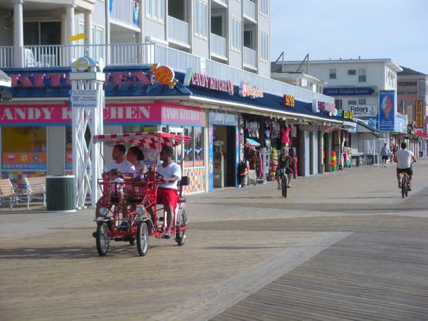 a couple of people riding bikes down a street