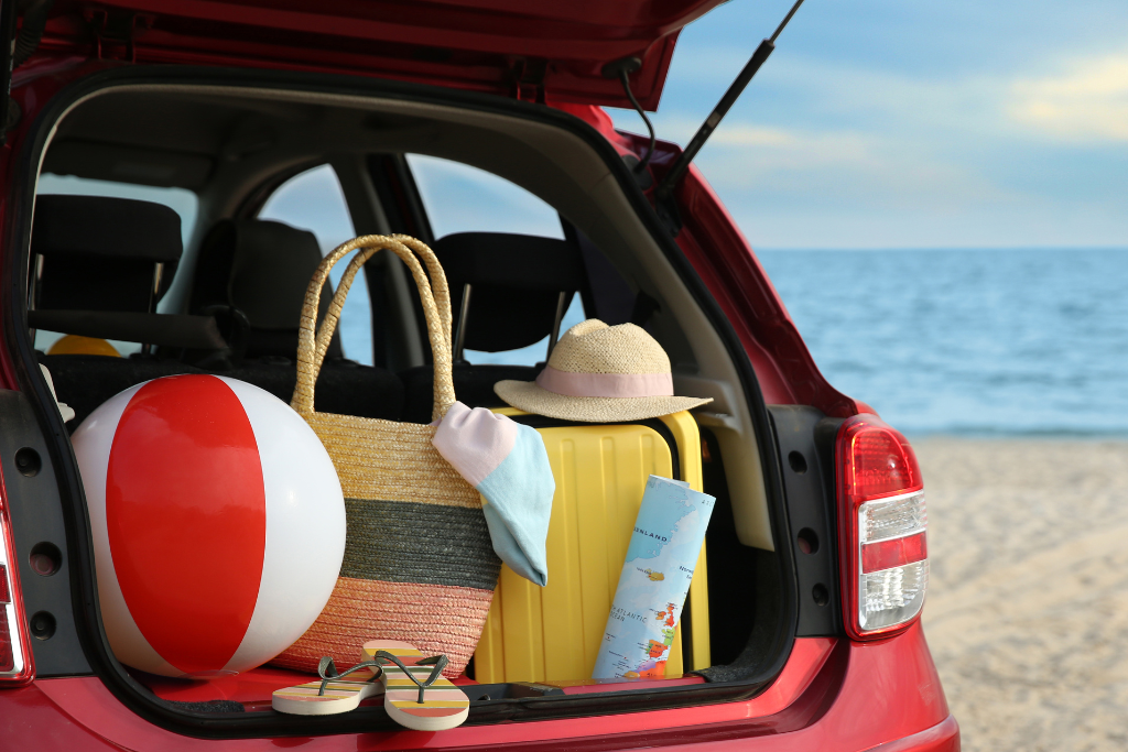 Trunk of car packed with beach in background