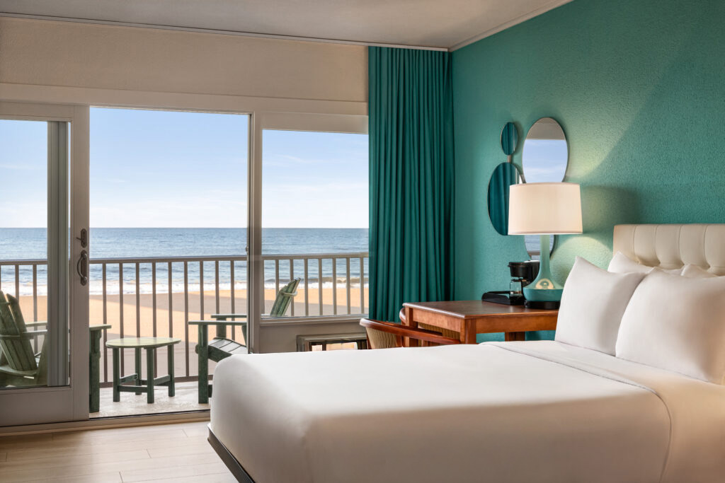 a hotel room with a balcony overlooking the beach