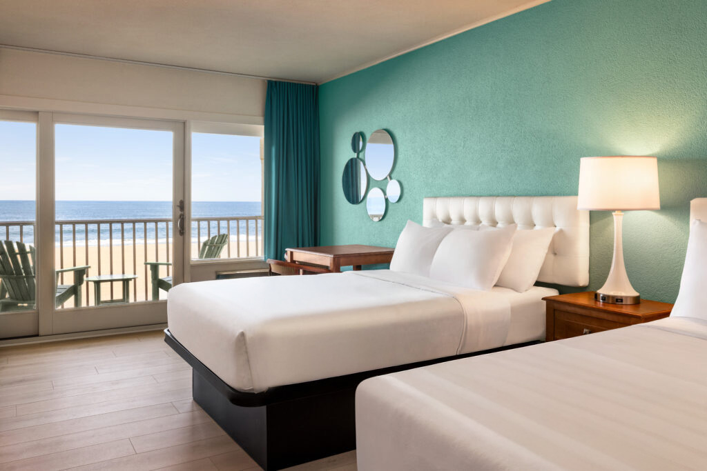 a hotel room with two beds and a balcony