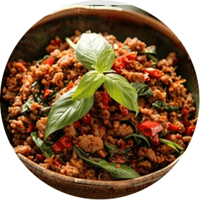 a wooden bowl filled with meat and vegetables