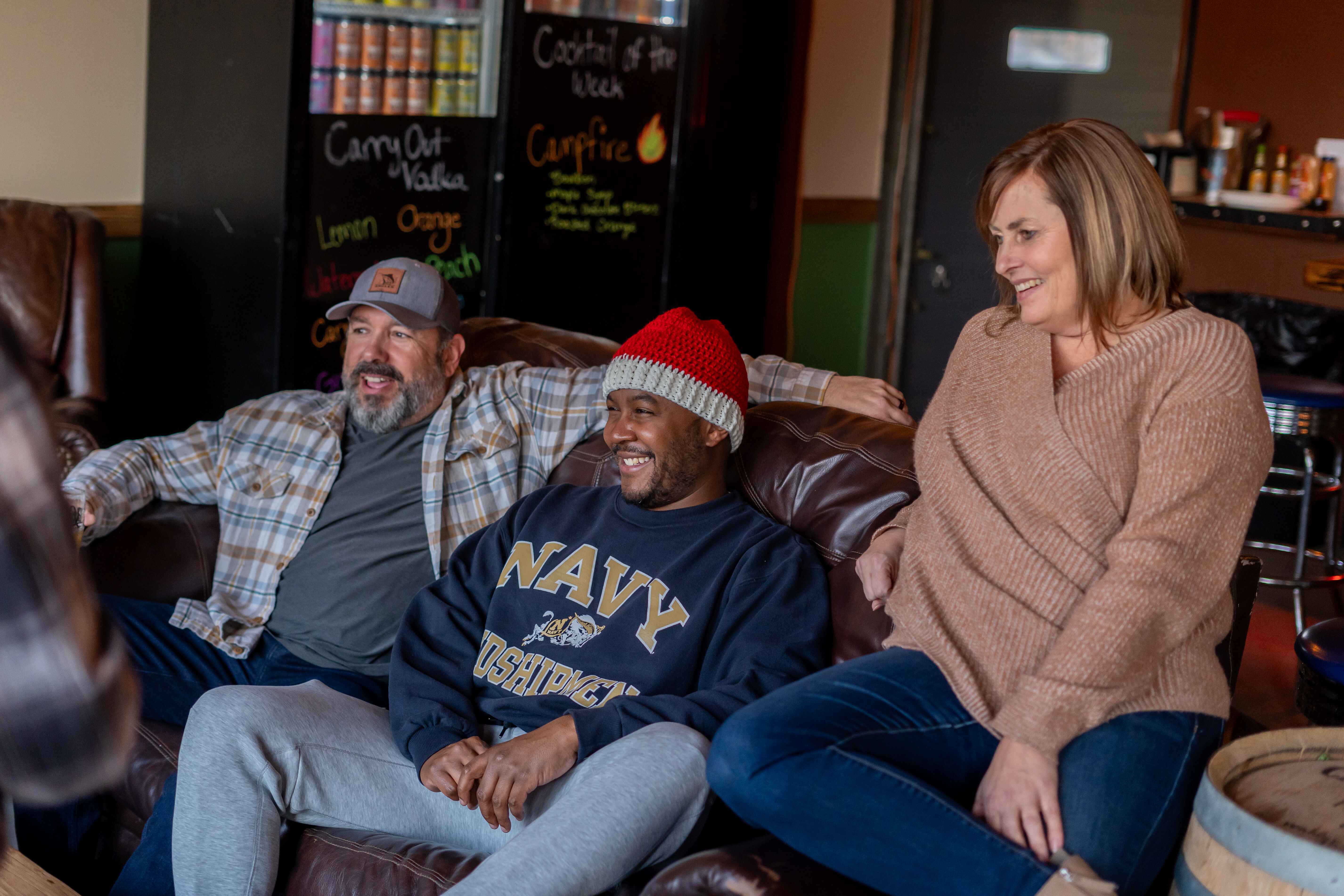 a group of people sitting on top of a couch