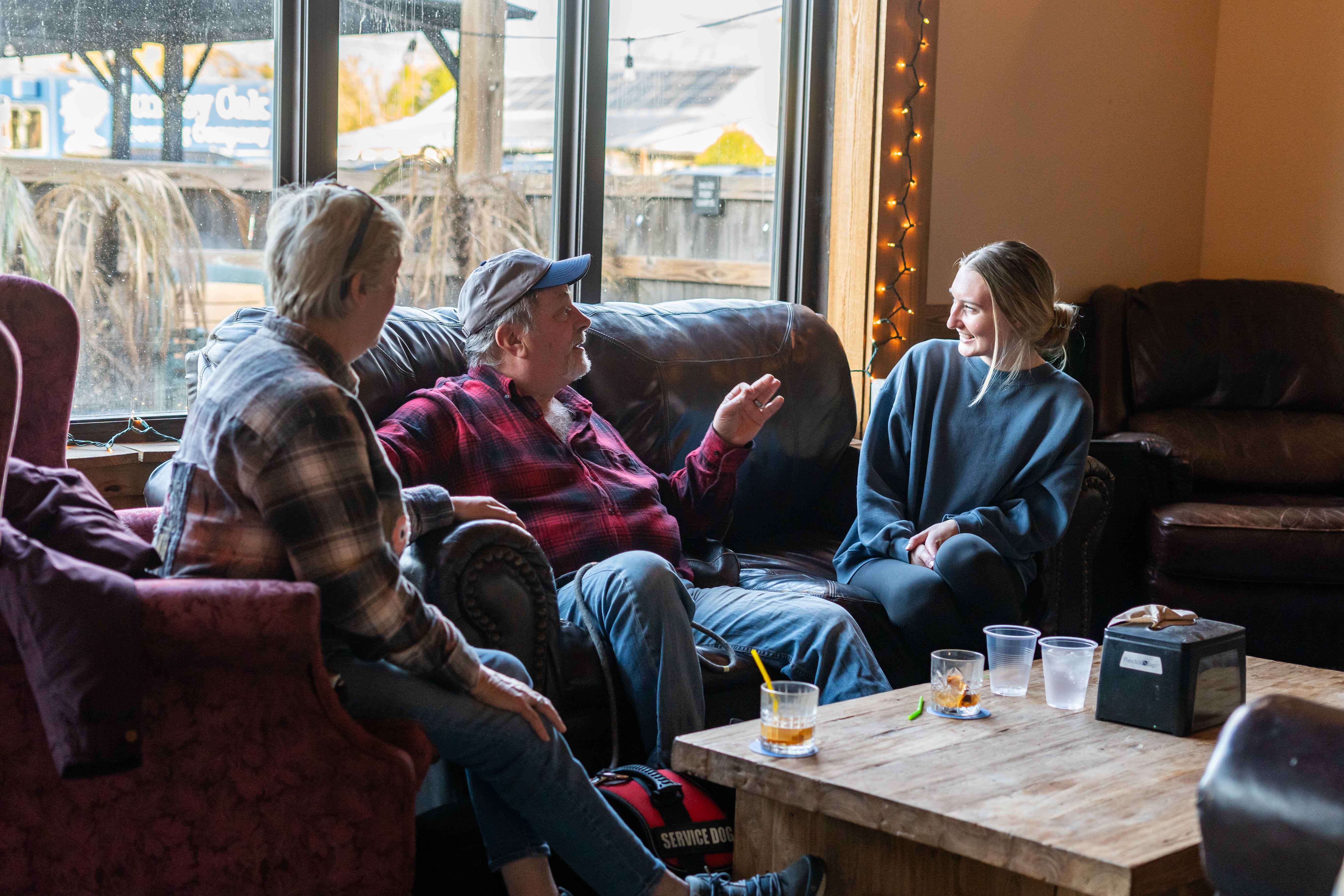 a group of people sitting around a living room