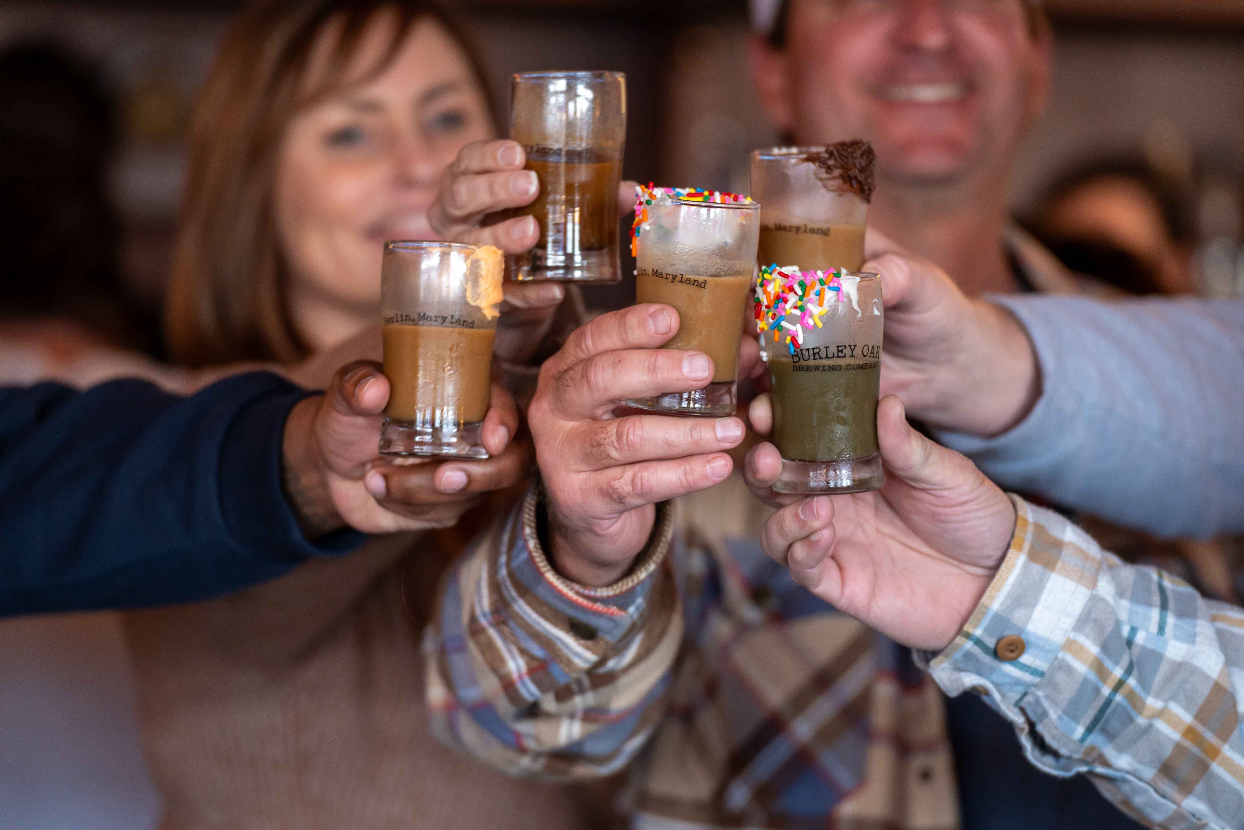 a group of people holding up glasses of drinks