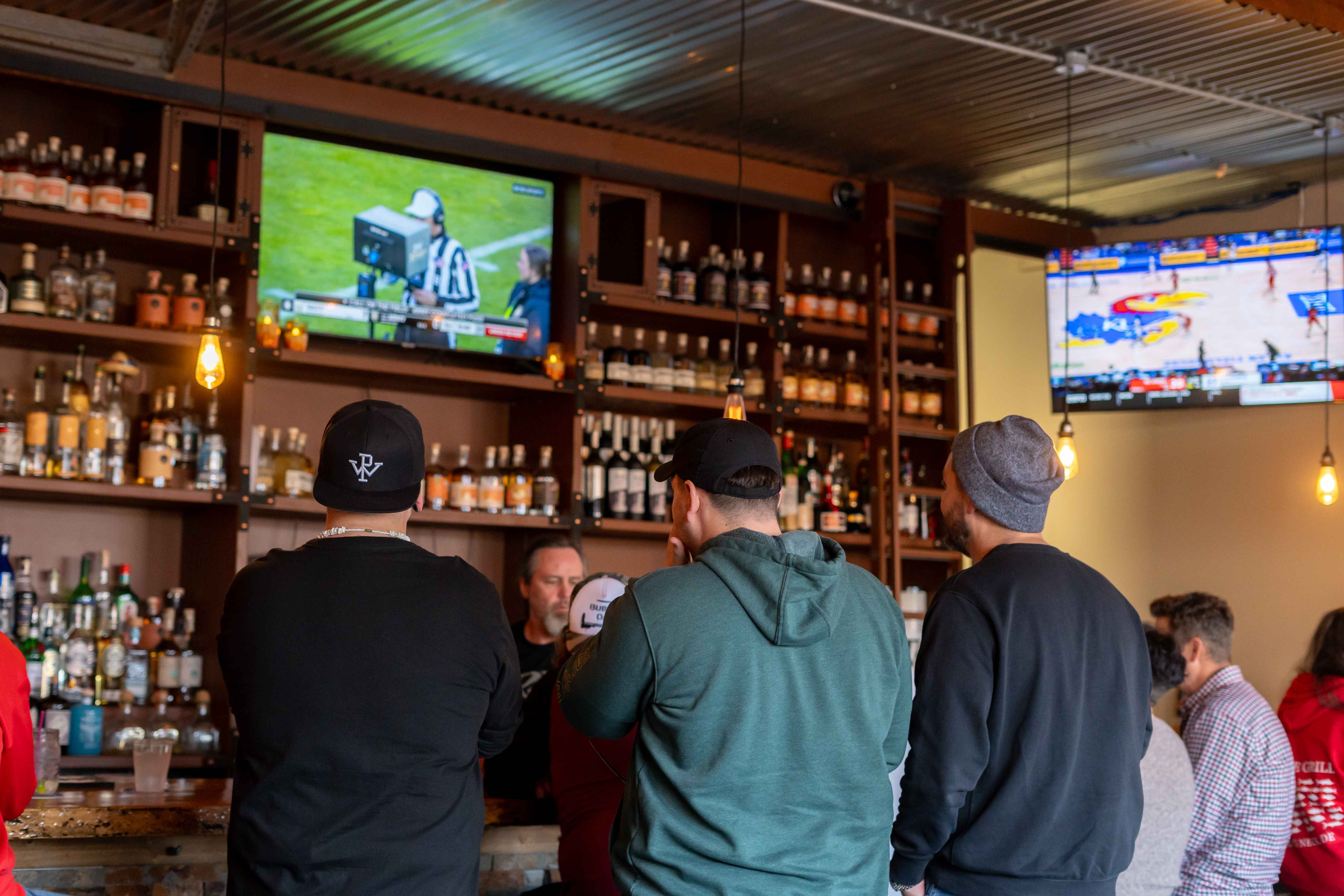 a group of people standing in front of a bar