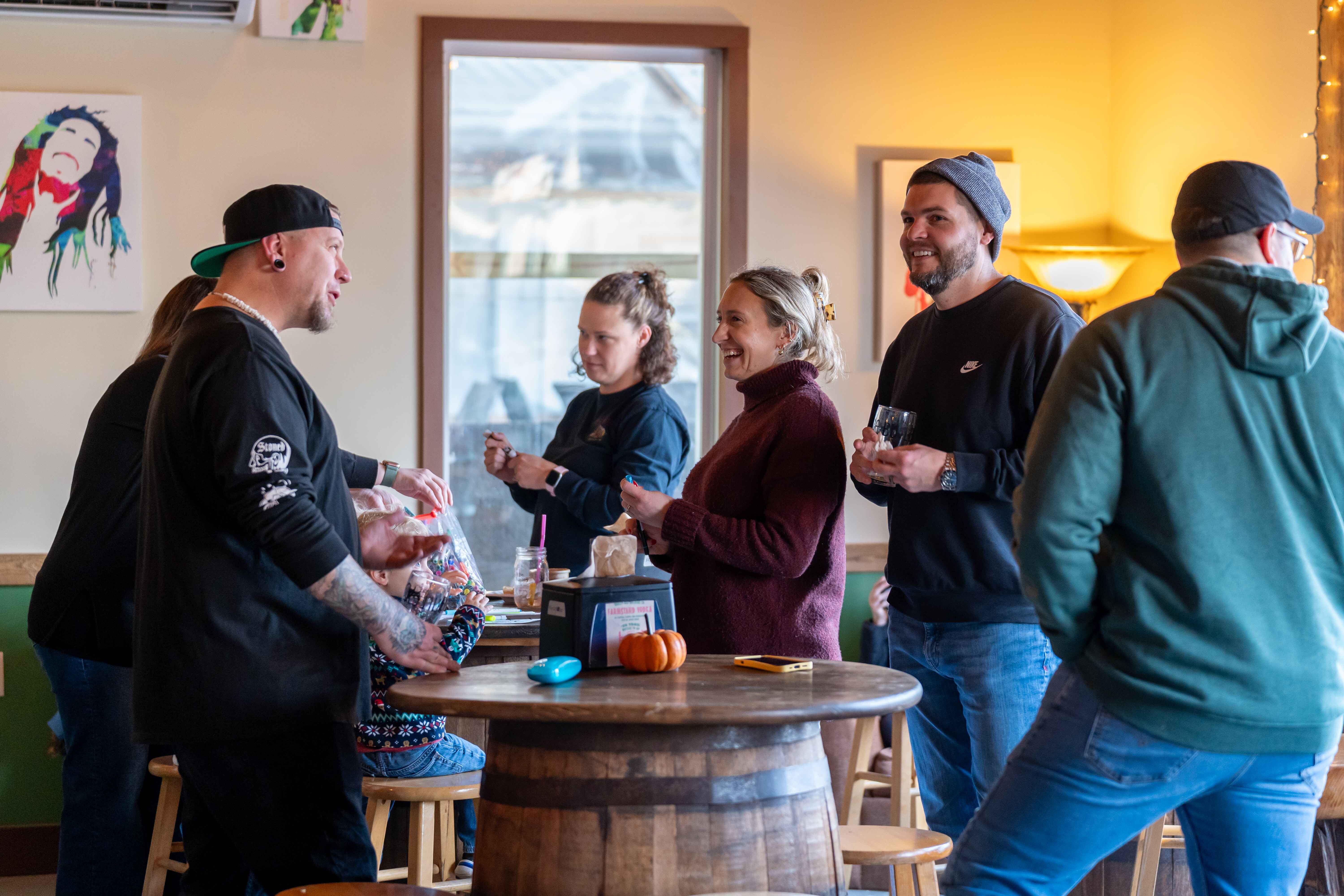 a group of people standing around a table