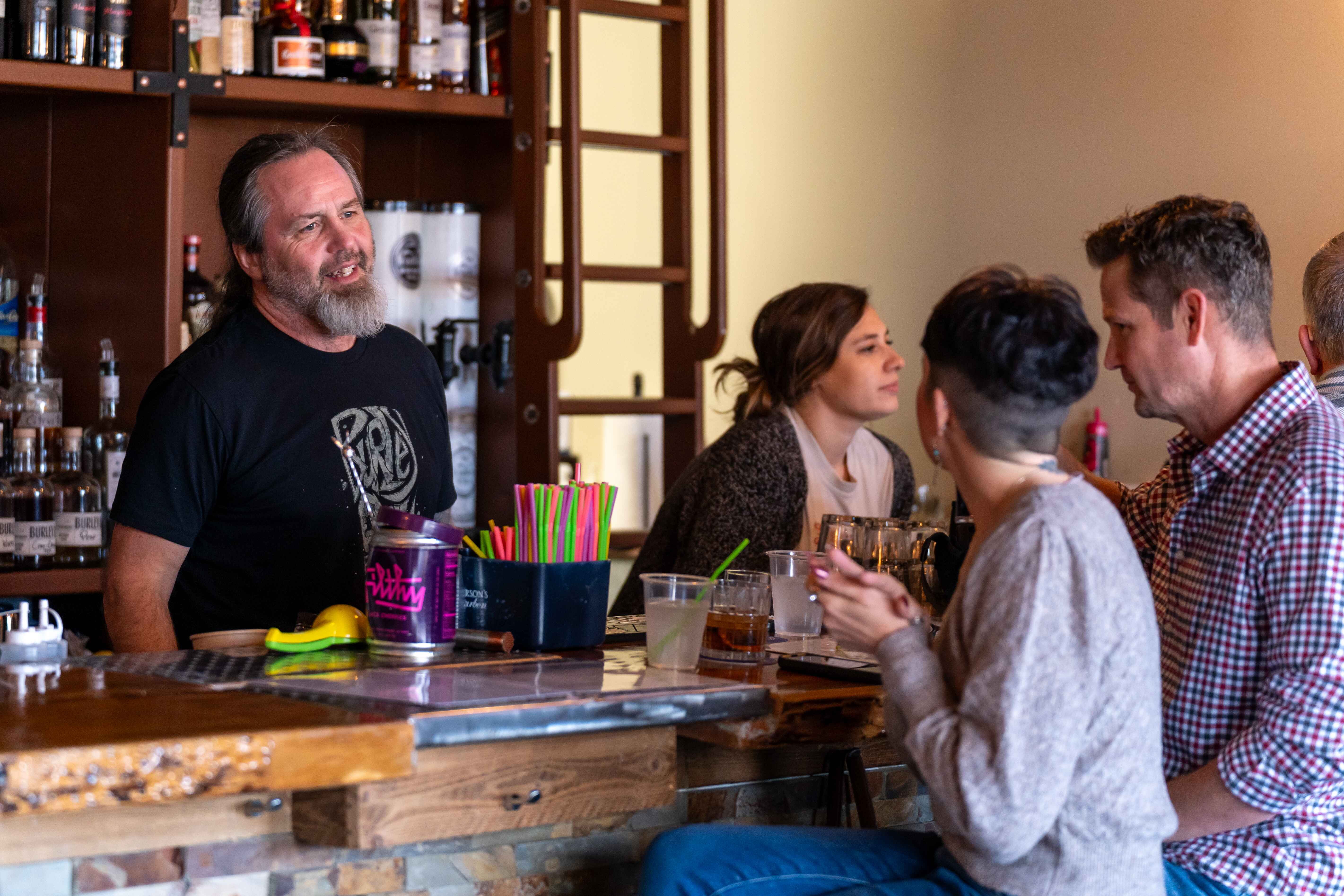 a group of people sitting at a bar