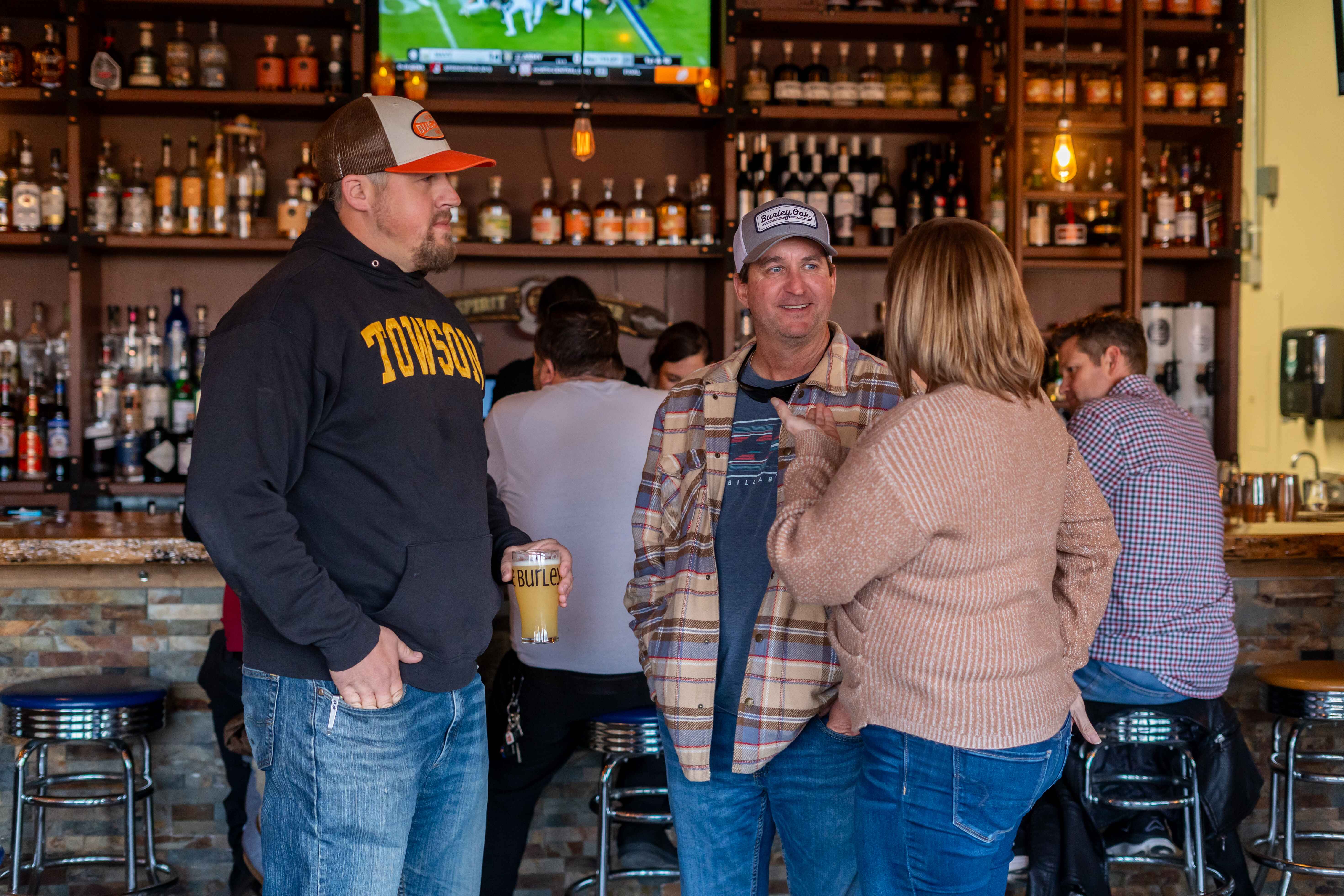 a group of people standing around a bar