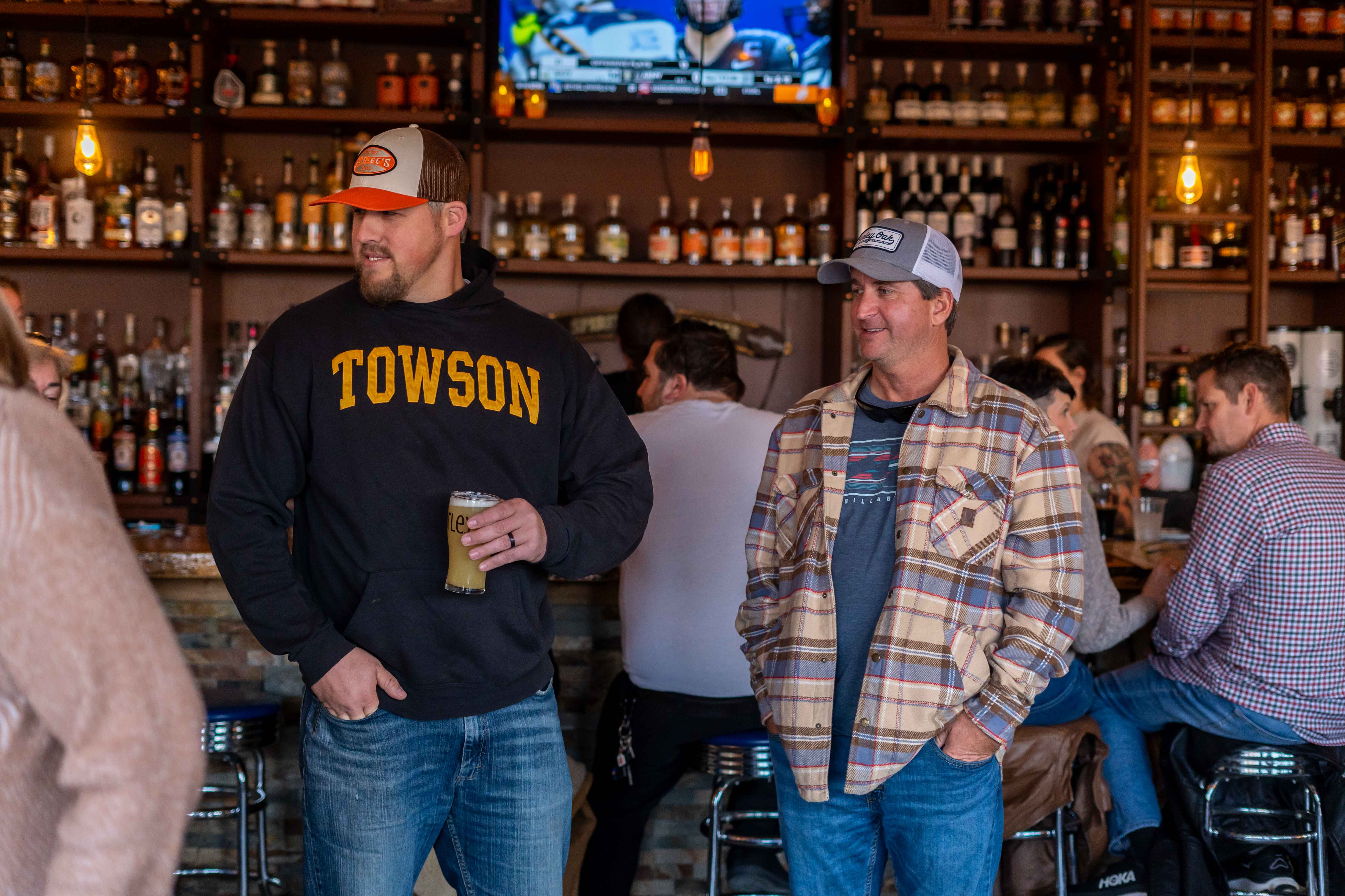 a group of men standing in front of a bar