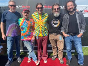 a group of men standing next to each other on a red carpet