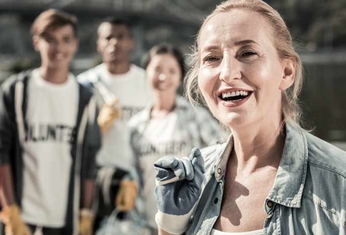 blonde girl smiling with group of volunteers