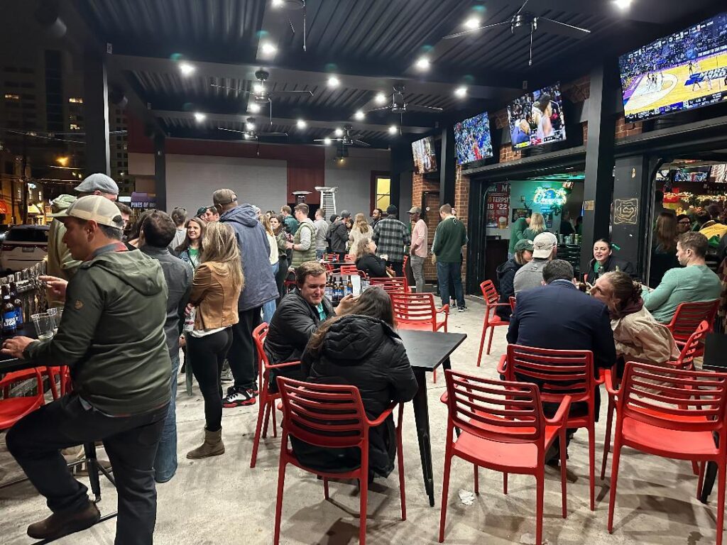 a group of people sitting around tables in a room