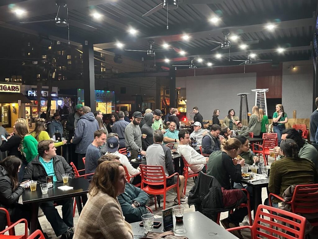 a large group of people sitting at tables in a restaurant