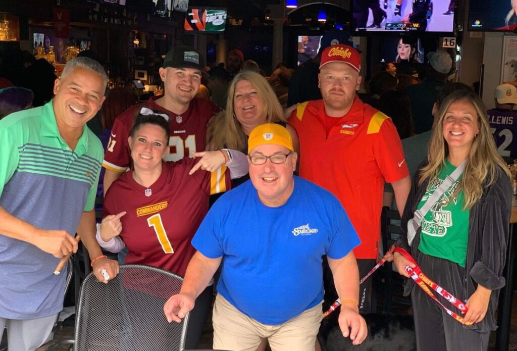 a group of people standing around each other