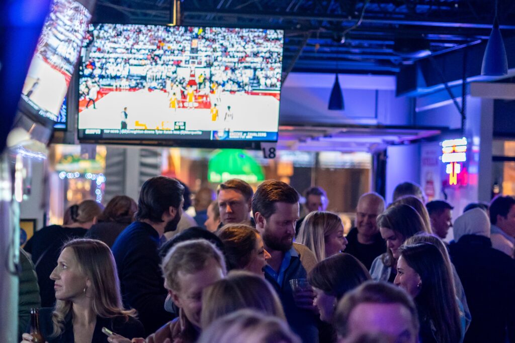 a large group of people standing in a room