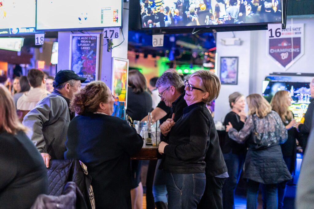 a group of people standing around a bar