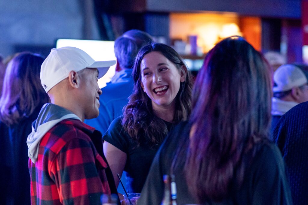 two people are talking at a party