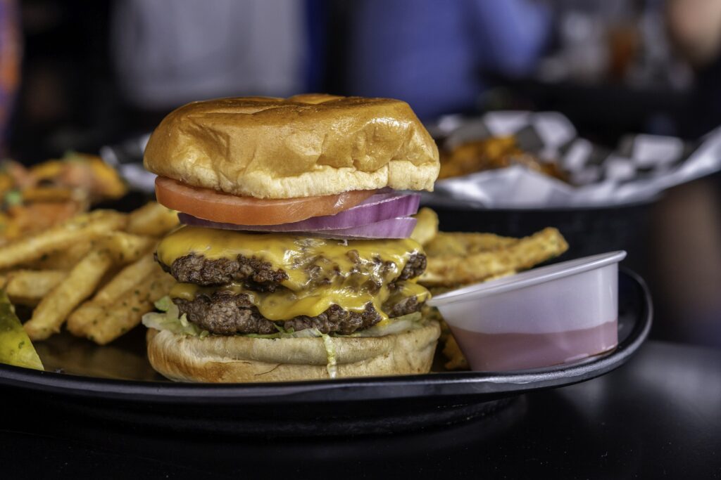 a cheeseburger with fries on the side