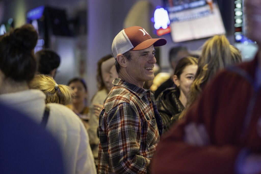 a man wearing a plaid shirt and orange hat