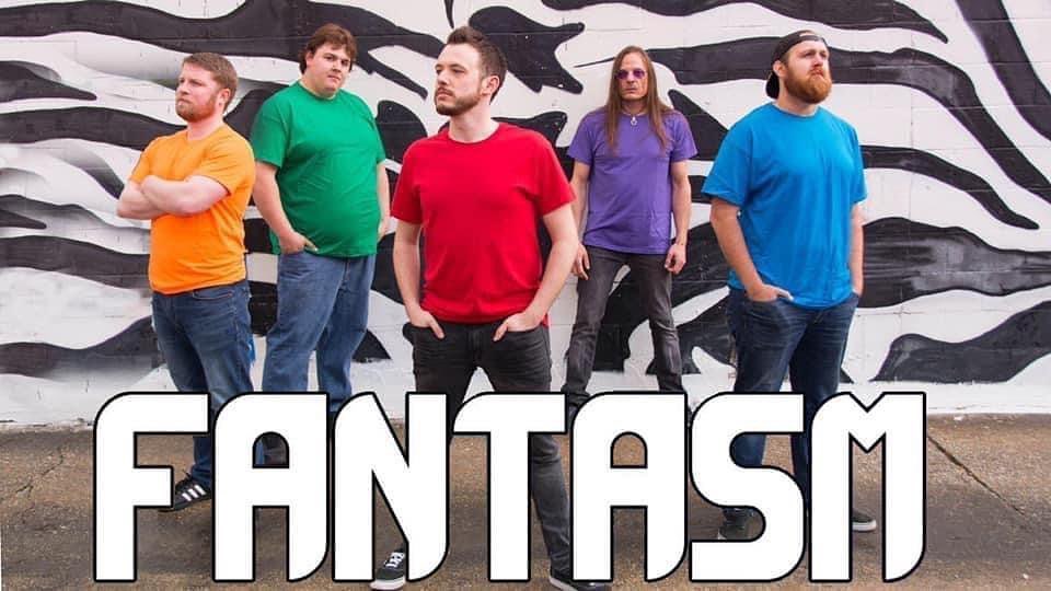 a group of men standing in front of a wall