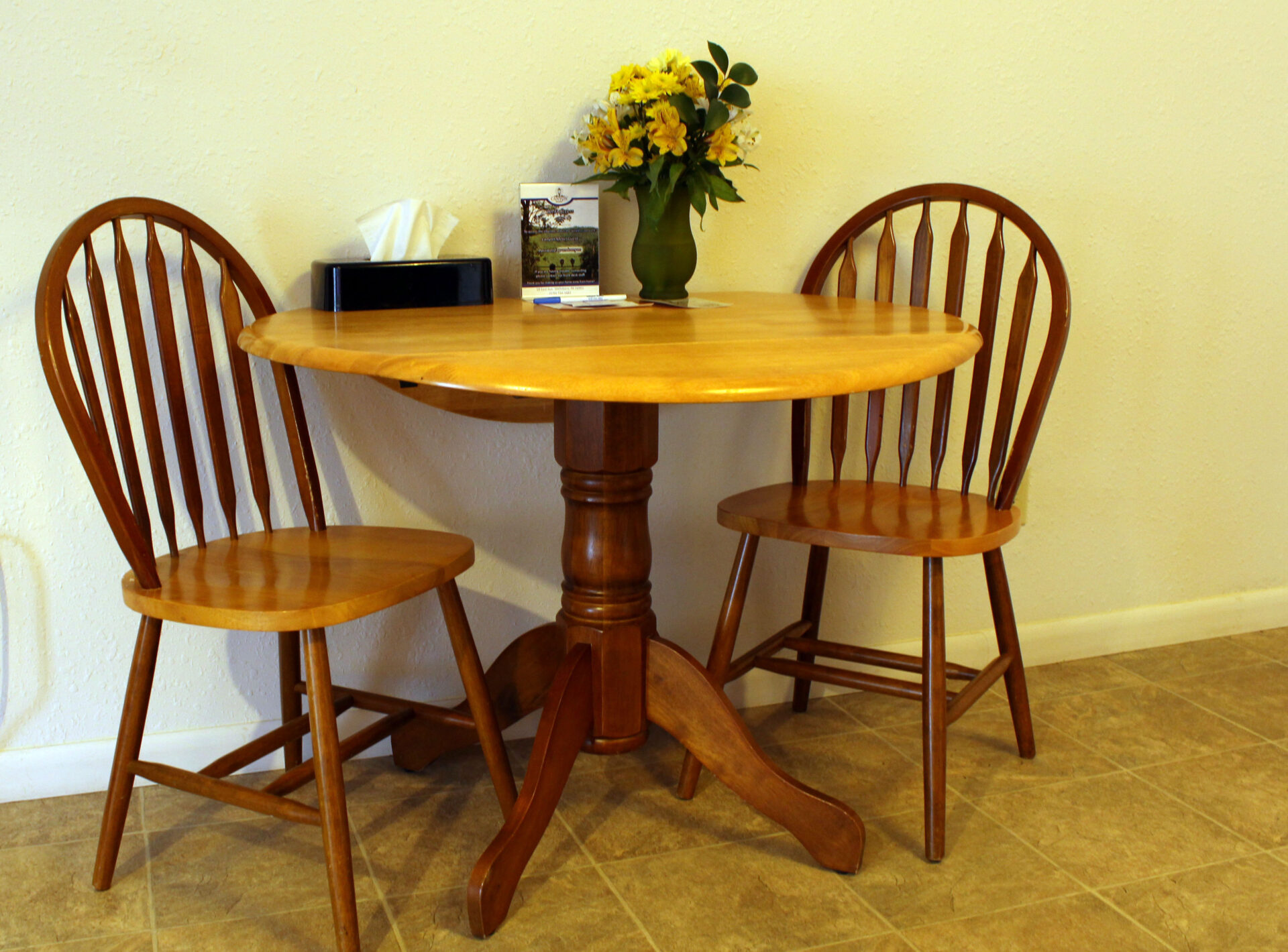 Small round wooden table with two chairs