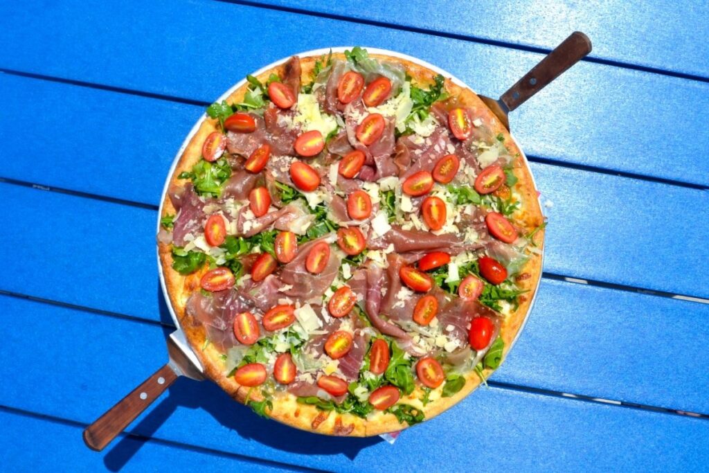 a pizza sitting on top of a blue table
