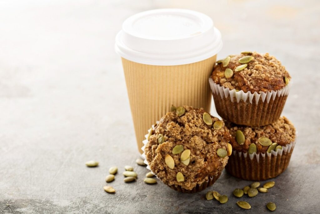 three muffins and a cup of coffee on a table