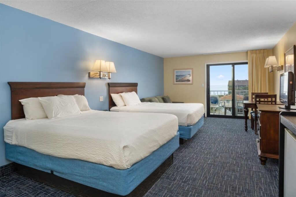 a hotel room with two beds and a television