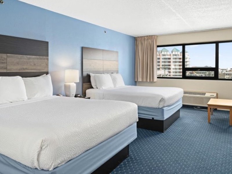 a hotel room with two beds and a television