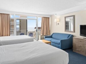 a hotel room with two beds and a television