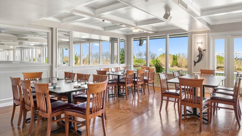 a dining room with wooden tables and chairs