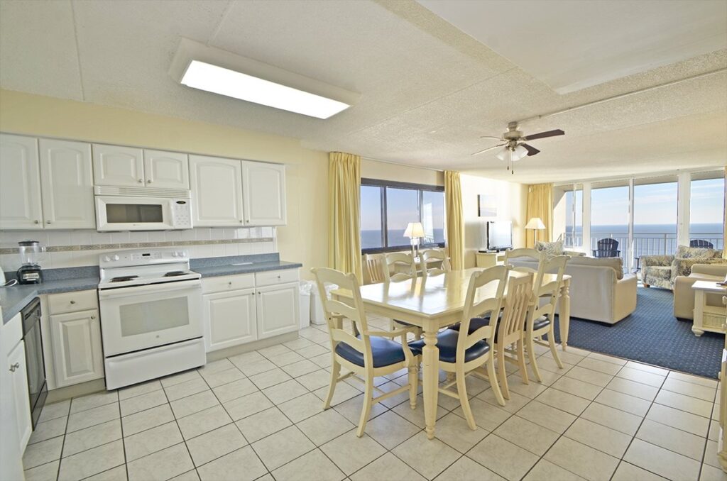 a kitchen and living room with a large window