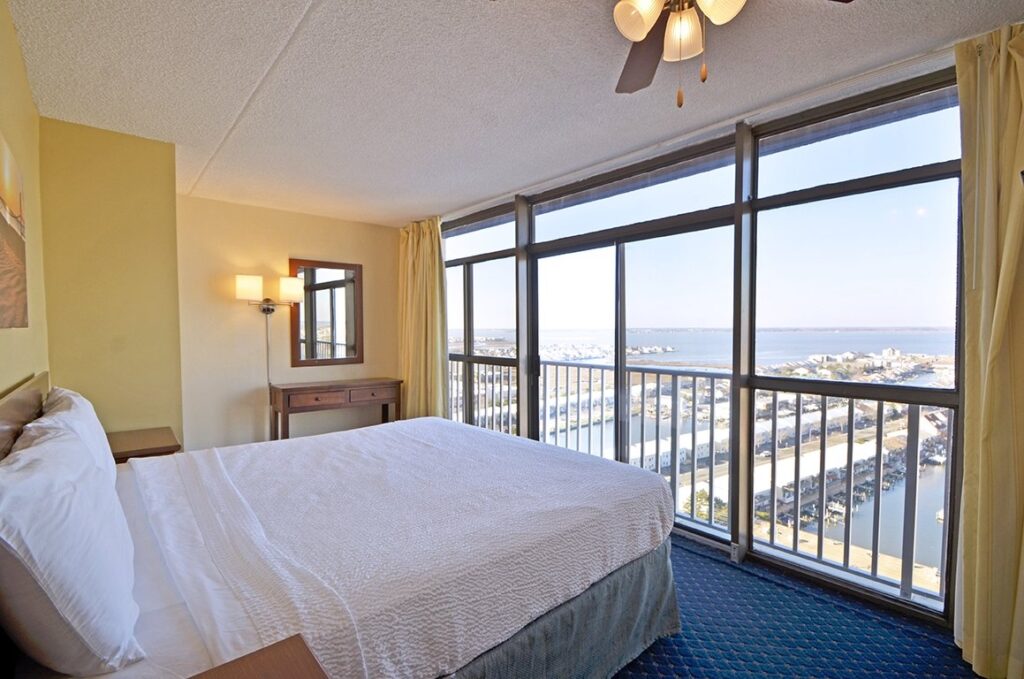 a bedroom with a large bed and a balcony