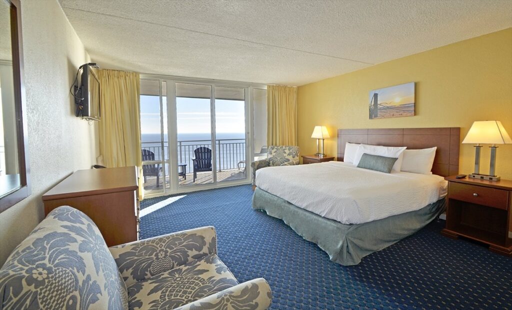 a hotel room with a large bed and a balcony