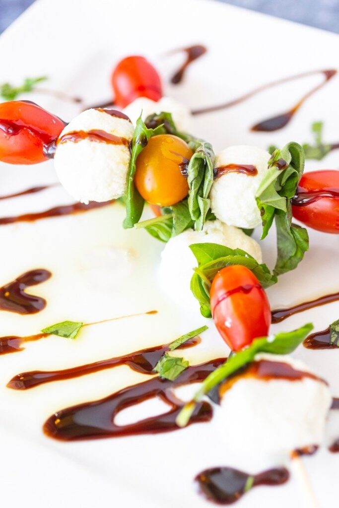 a white plate topped with vegetables and sauce