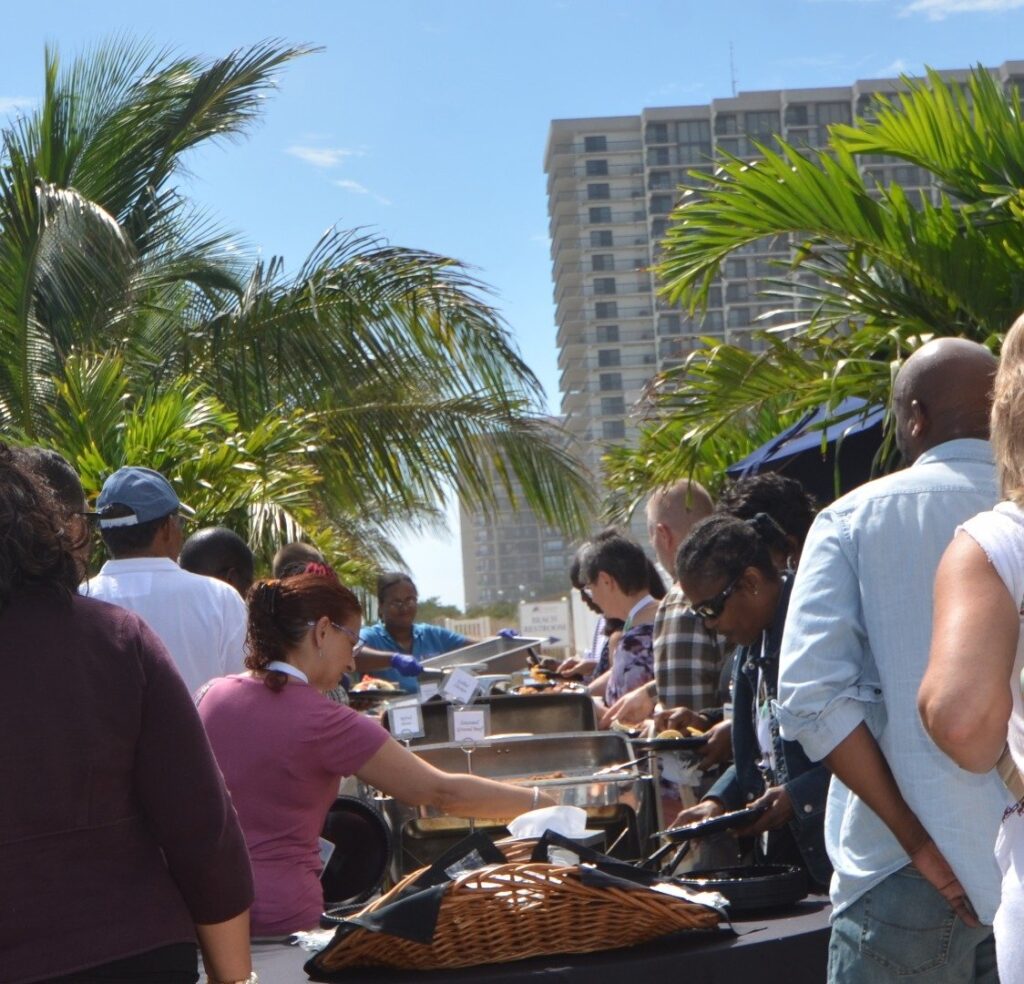 a group of people standing around a table