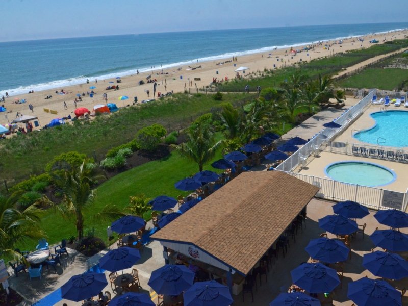 an aerial view of a beach resort and pool