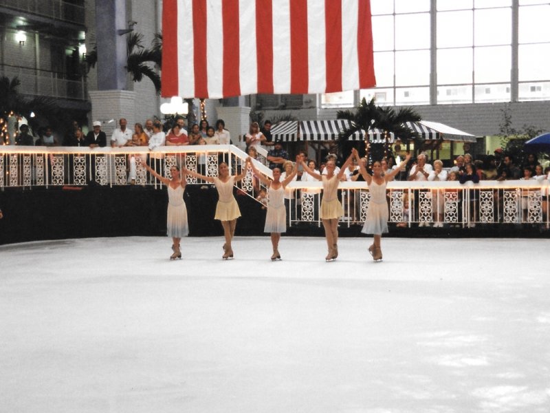 three girls are holding up their arms in front of an american flag