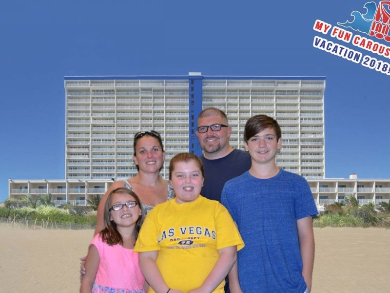 a family poses for a picture on the beach